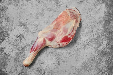 Raw lamb shoulder chump on on shabby grey background