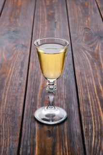Vodka infused with berries on wooden background