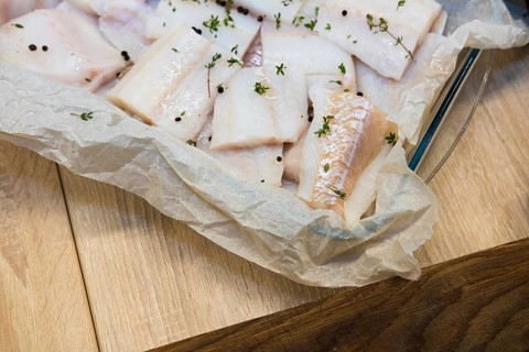 Fresh white fish fillet on cooking paper