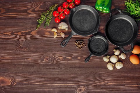 Table with cast-iron pan and spices