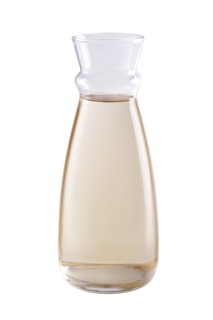 Pitcher with white wine isolated on white