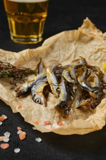 Closeup view of smoked smelt in wrapping paper