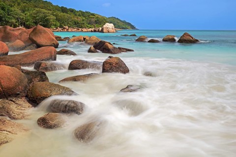 Granite rocks and beach of Anse Lazio in the evening