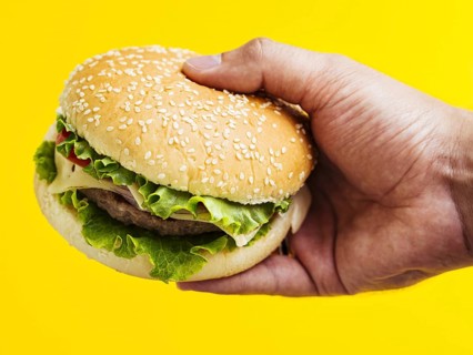 Man holding cheeseburger with seeds. Resolution and high quality beautiful photo