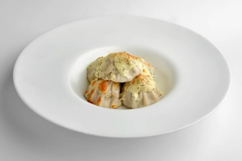 Deep plate with fried pelmeni with cheese