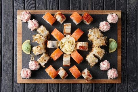 Big set of rolls served on stone plate. Layout for menu