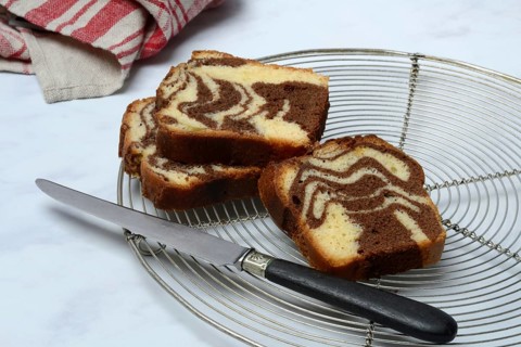 Marble cake and knife on cake rack