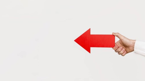 Hand holding red arrow
