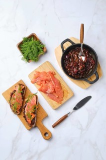 Overhead composition with salmon sandwich with caramelised onion