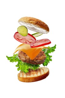 Burger with flying ingredients isolated on white background