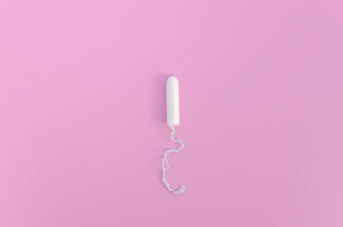 Minimalist tampon pink background top view