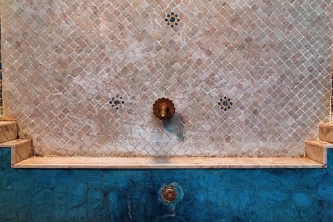 Ornate tap in tiled wall