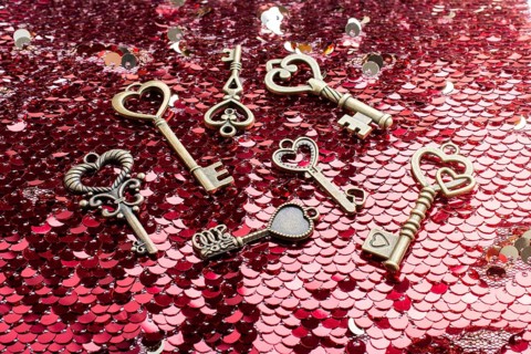 Heart shaped retro metal keys on bright background