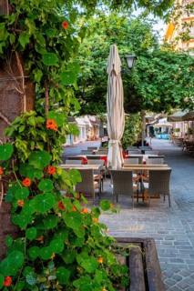 Street cafe in scenic picturesque streets of Chania venetian town with coloful old houses. Chania greek village in the morning. Chanica