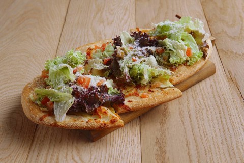 Freshly baked focaccia with salad leaves
