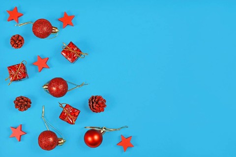 Christmas flat lay with red ornaments in shape of tree baubles