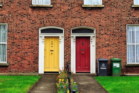 Typical terraced houses with small front garden and colourful doors