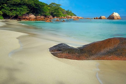 Beach and rocks of Anse Lazio in the evening