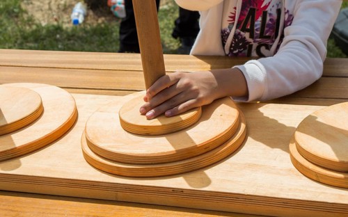 Hand holding wooden puzzle element in hand