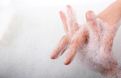 Hand washing and soap foam on a foamy background