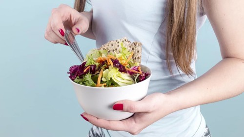 Woman holding big bowl with vegetable salad. Resolution and high quality beautiful photo