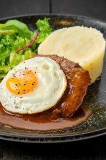 Closeup view of beef cutlet with fried egg