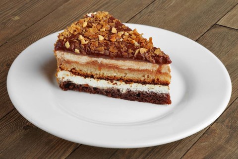 Chocolate sliced cake on wooden table