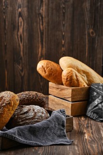 Assortment of cereal bread made of different seeds on wooden table