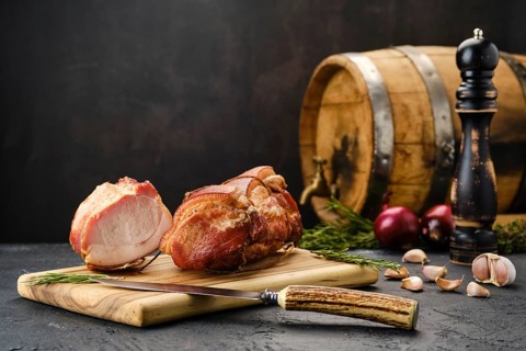 Smoked lamb meat on wooden cutting board