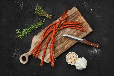 Overhead view of long thin homemade pork sausages with garlic