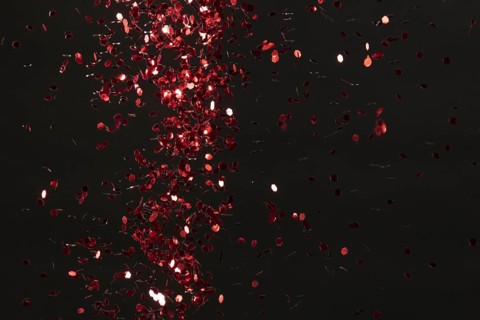 Red glitter on black background