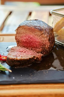 Grilled big fillet mignon beef steak cut on half