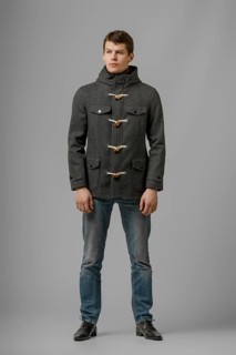 Full length portrait of handsome man in warm woolen coat posing in studio