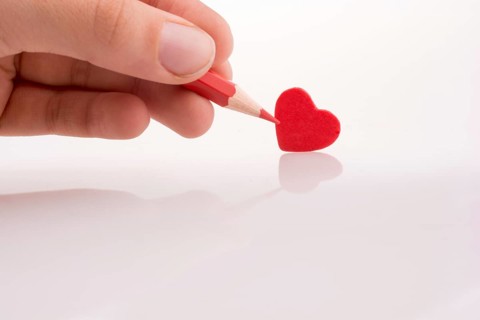 Pencil pointing a red heart
