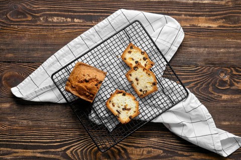 Overhead view of fresh biscuit cake with raisins on the table