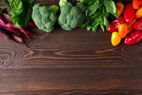 Fresh vegetables on dark wooden background