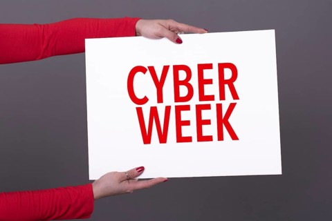 Female hands holding a cyber week poster. Studio shot