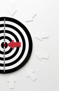 Flat lay target with arrows pointing bullseye