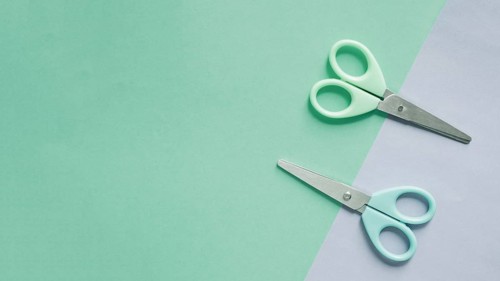 Overhead view two scissors dual colorful background 1