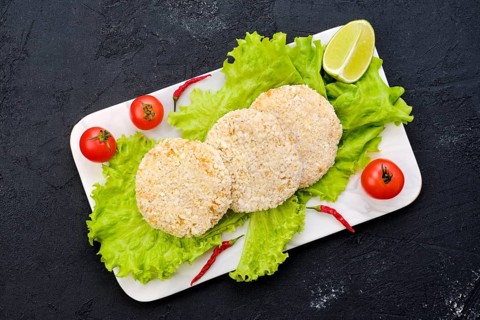Top view of trout meat cutlet in breading