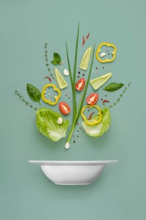 Recipe of vegetable salad organized into component parts over solid background