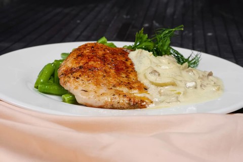 Closeup grilled steak and french green bean with creamy onion sauce