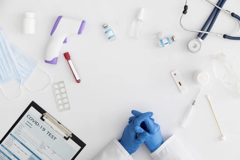 Covid form surrounded by medicine thermometer