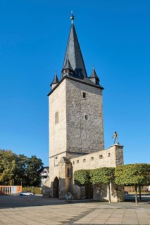 City wall at the Johannistorturm with the bronze figure of the polymath Adam Olearius by sculptor Bernd Goebel