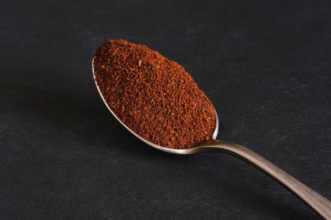 Macro photo of spoon with ground coffee