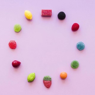 Circle made with sugar jelly candies pink background