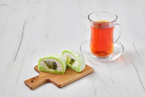 Sweet dessert mochi with kiwi cut on half with fruit tea