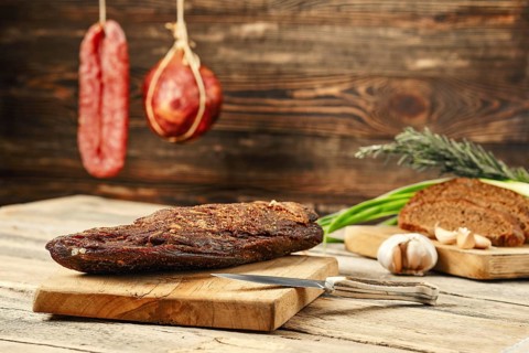 Air dried beef meat on wooden cutting board