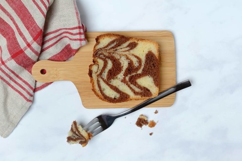Marble cake on wooden board and fork
