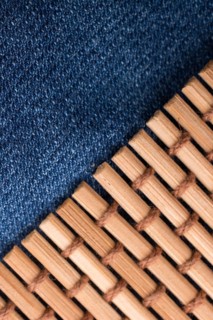 Straw mat placed on denim canvas as a background